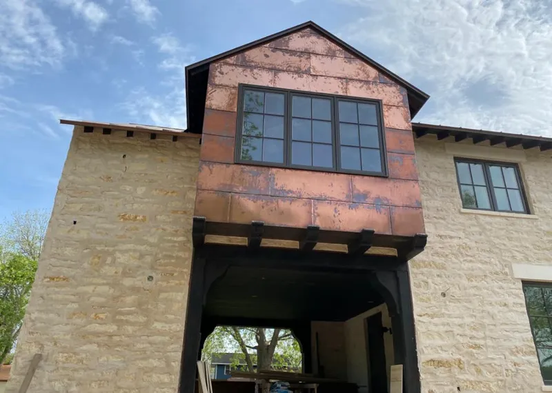 Copper metal panel facade on a stone building for Skylight Installation in Canton